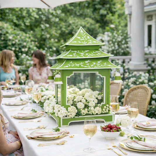 a table with flowers and a green lantern
