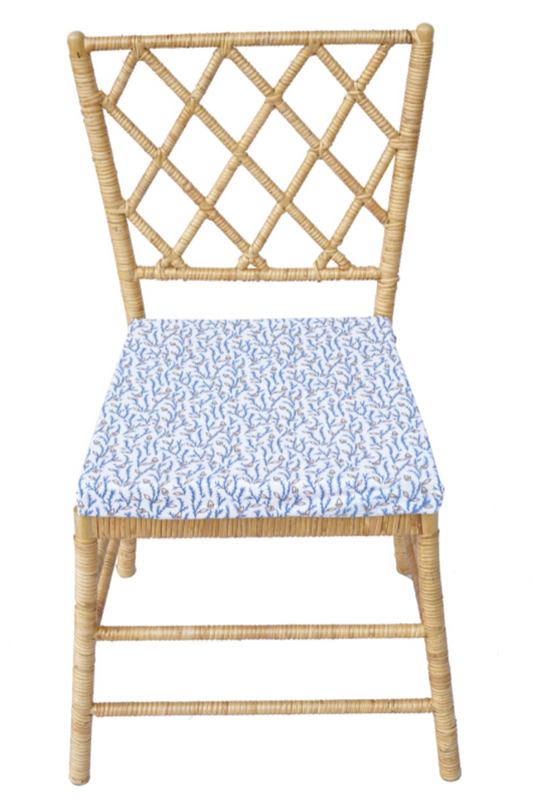 a wicker chair with a blue and white fabric seat