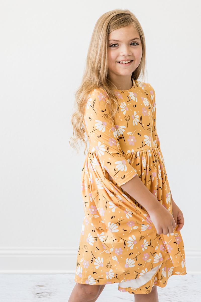 a girl in a yellow dress