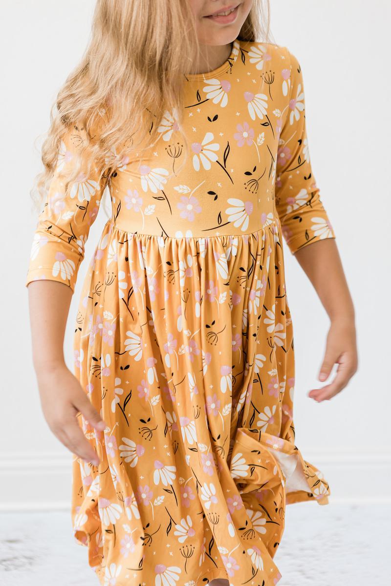 a girl wearing a yellow dress