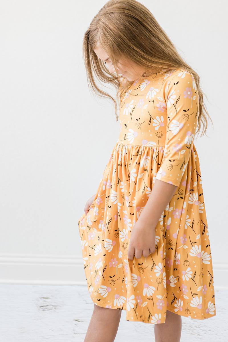 a girl in a yellow dress
