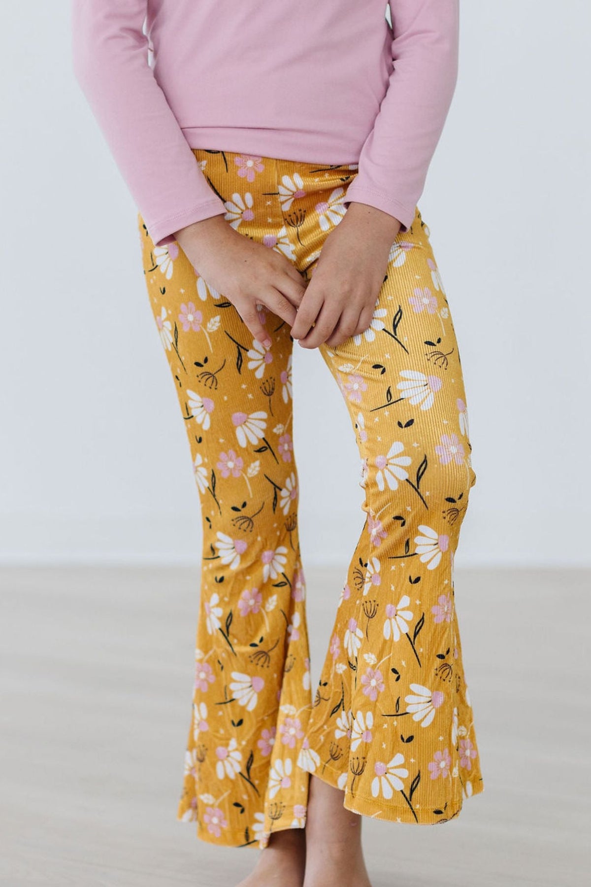 a person wearing yellow pants with white flowers