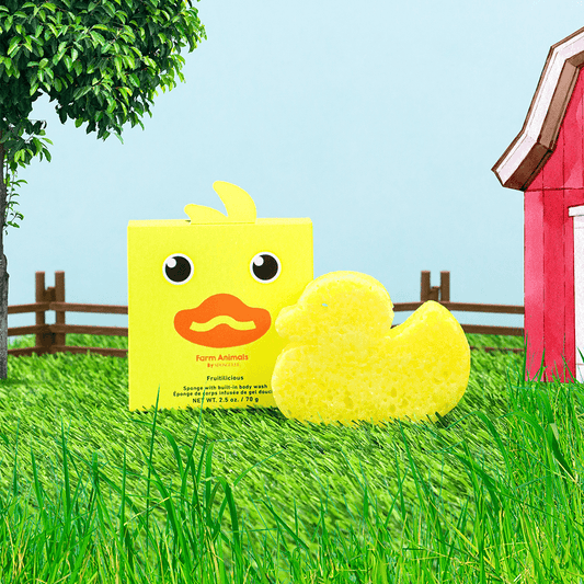 a yellow duck in the grass