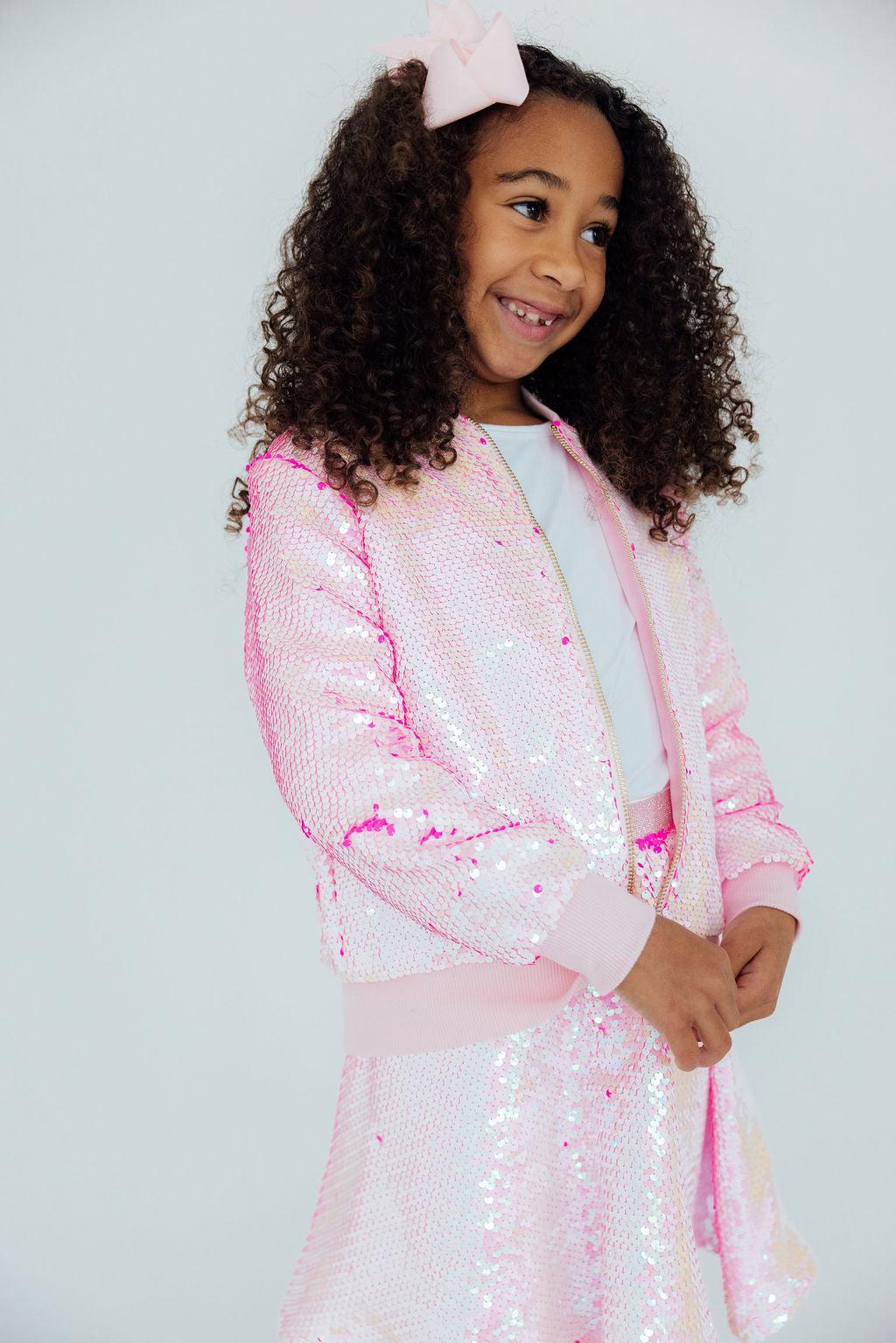 a girl in a pink outfit