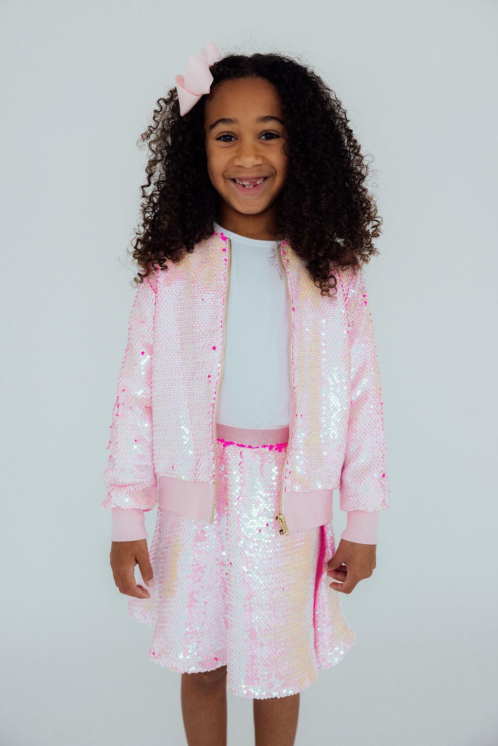a girl wearing a pink outfit