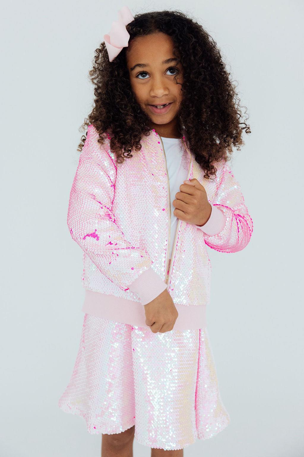 a girl wearing a pink jacket