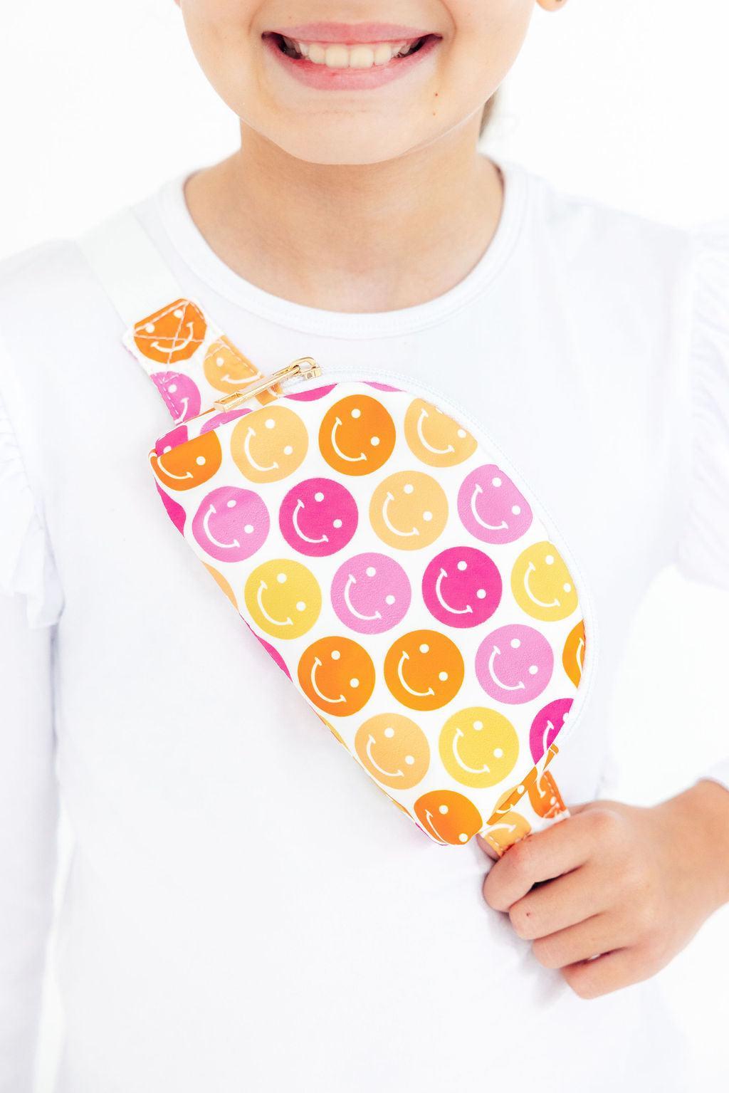 a person wearing a white shirt with a colorful bag