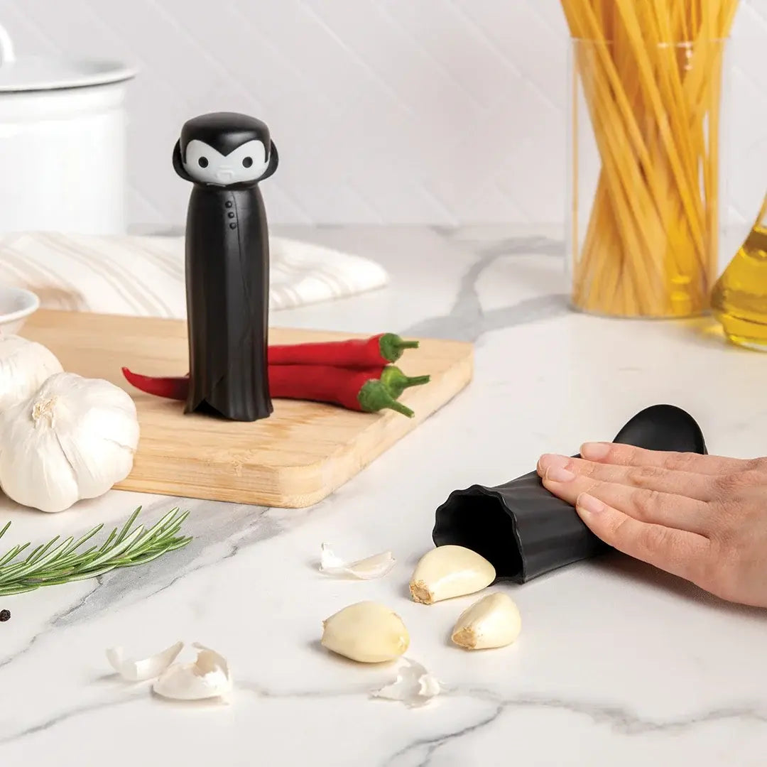a person's hand peeling garlic
