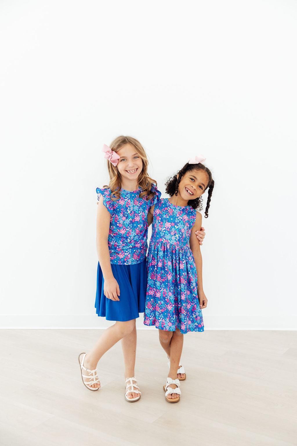 two girls in blue dresses