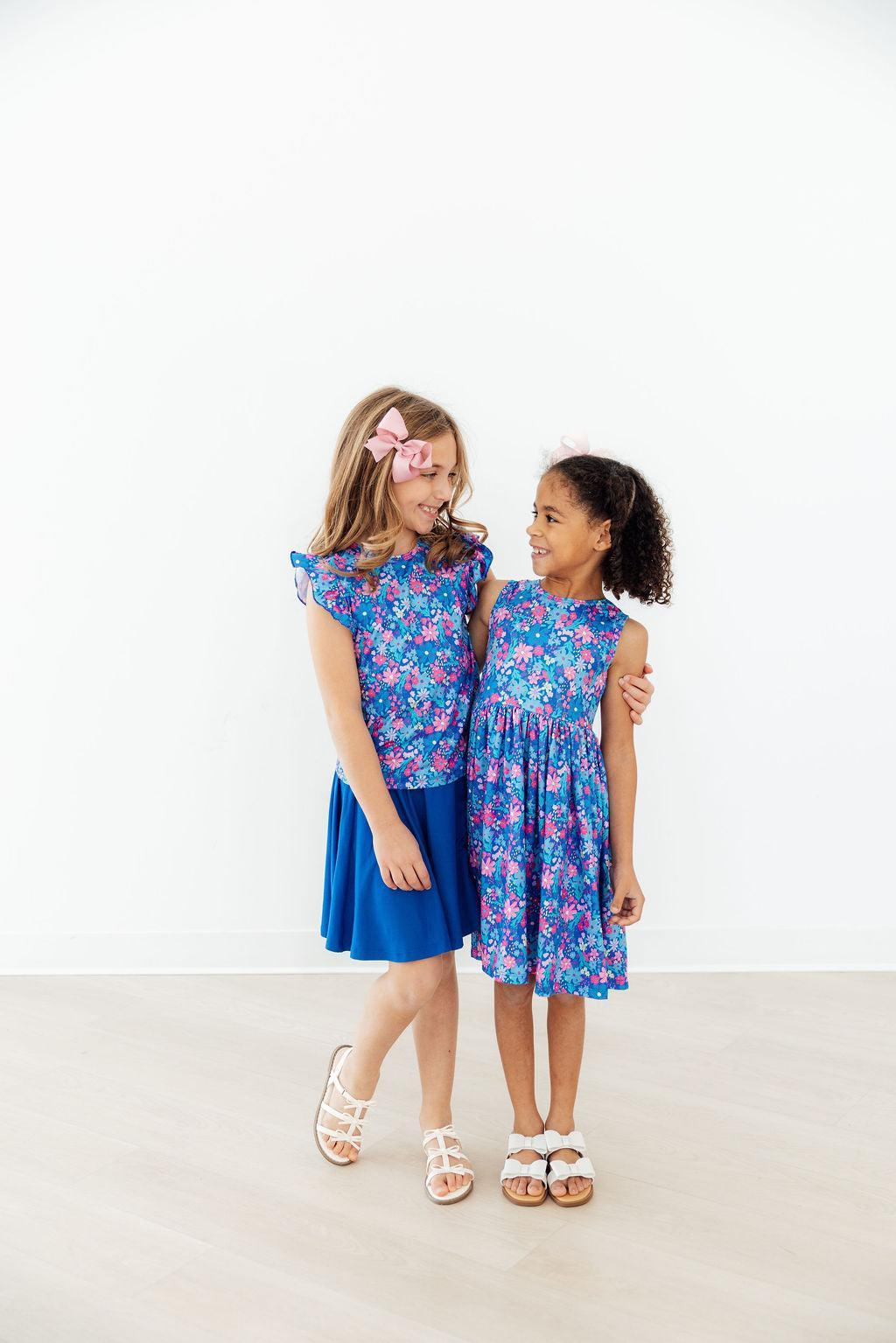 two girls in blue dresses