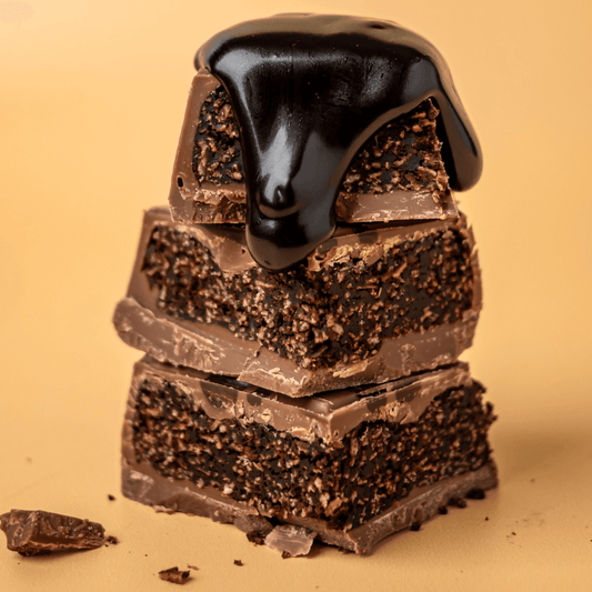 a stack of chocolate bars with chocolate sauce