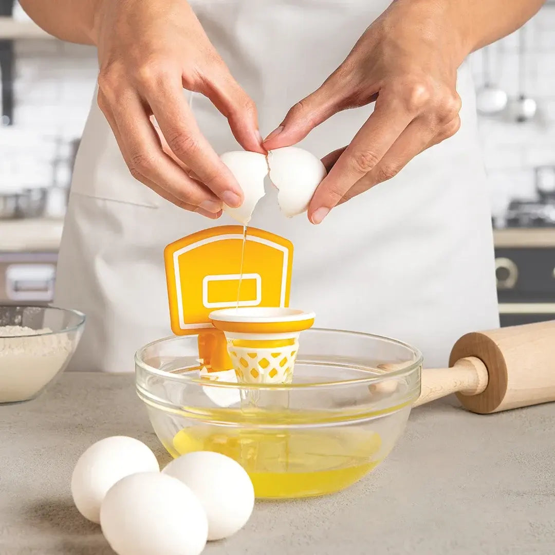 a person breaking an egg into a bowl of eggs