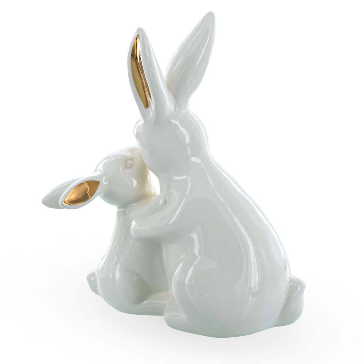 a white rabbit figurine with gold ears