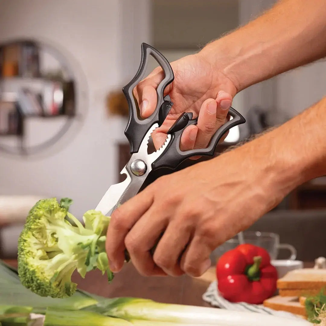 a person cutting a broccoli