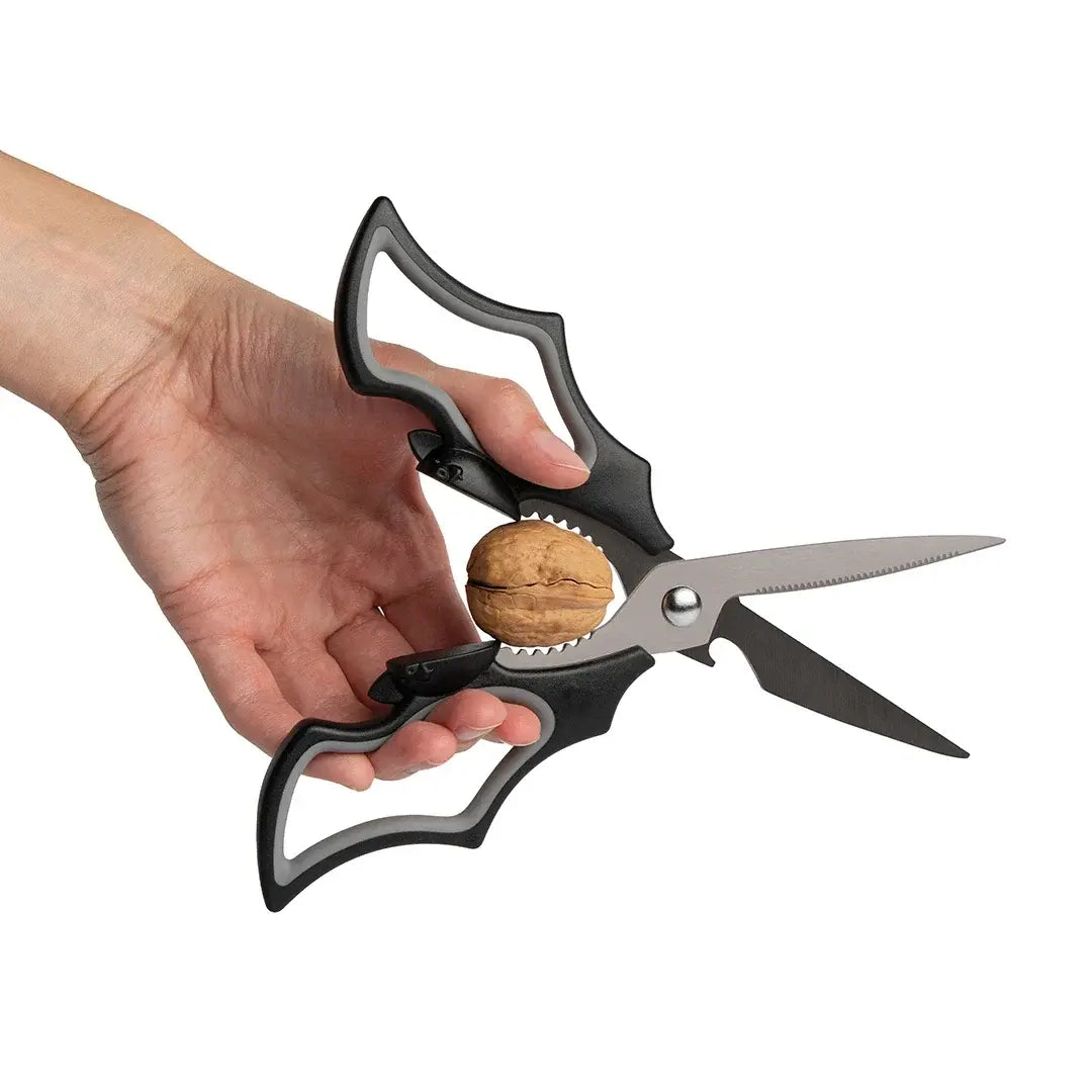 a hand holding a pair of scissors