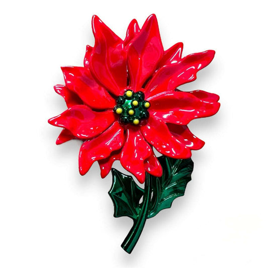 a red flower with green leaves