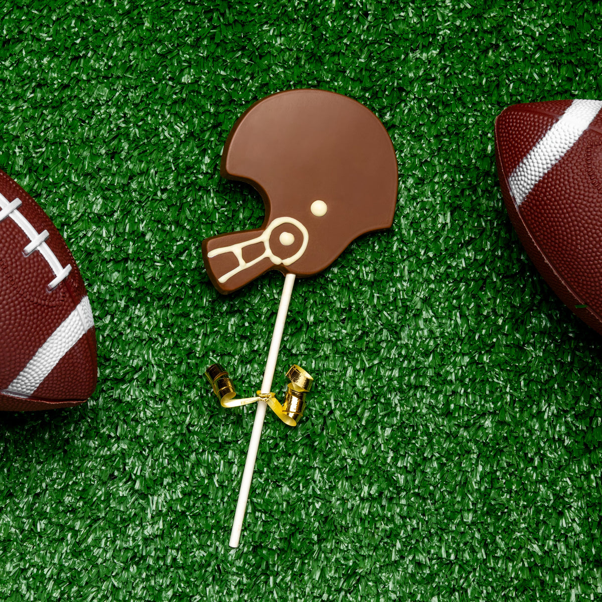 a chocolate football and a candy on a stick