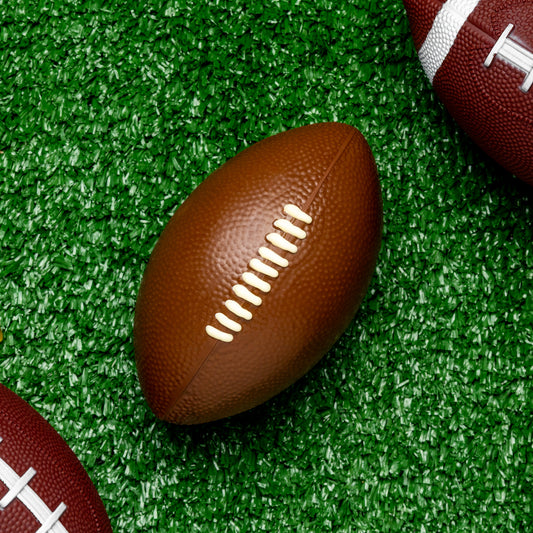 a group of footballs on a green surface