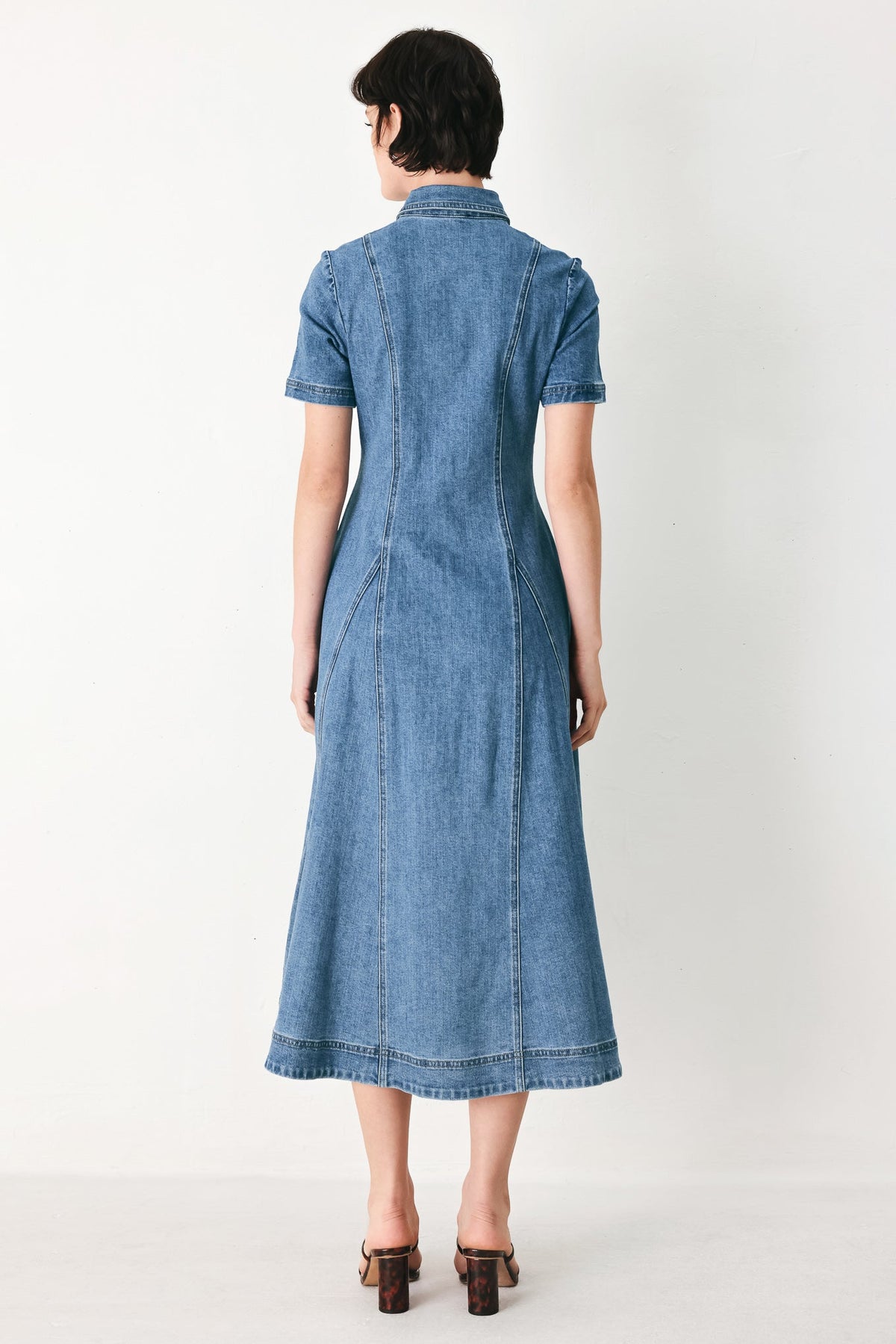 a woman in a denim dress