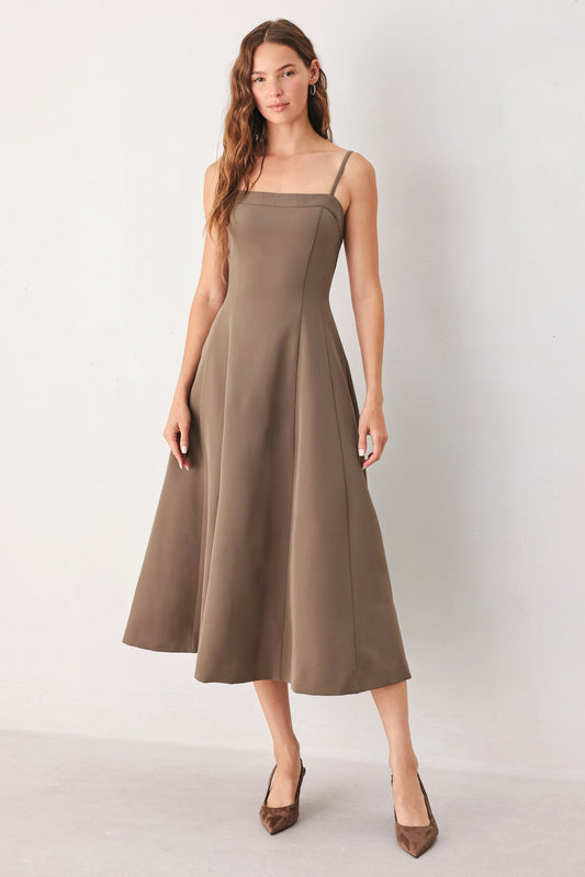 a woman in a brown dress