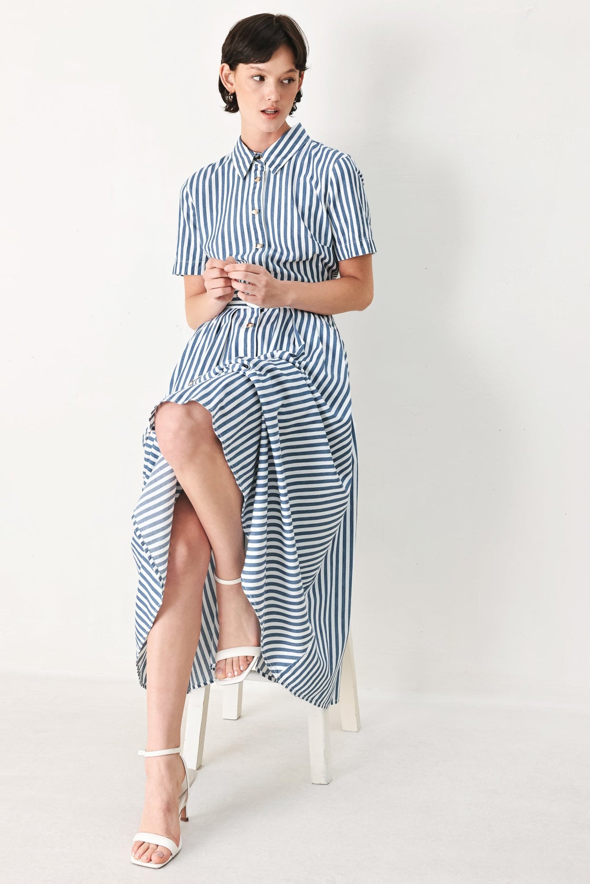 a woman in a striped dress