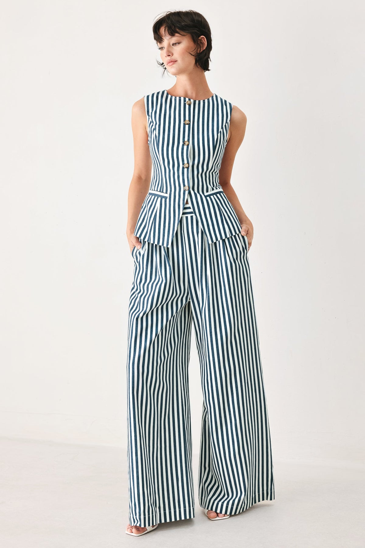 a woman in a striped jumpsuit