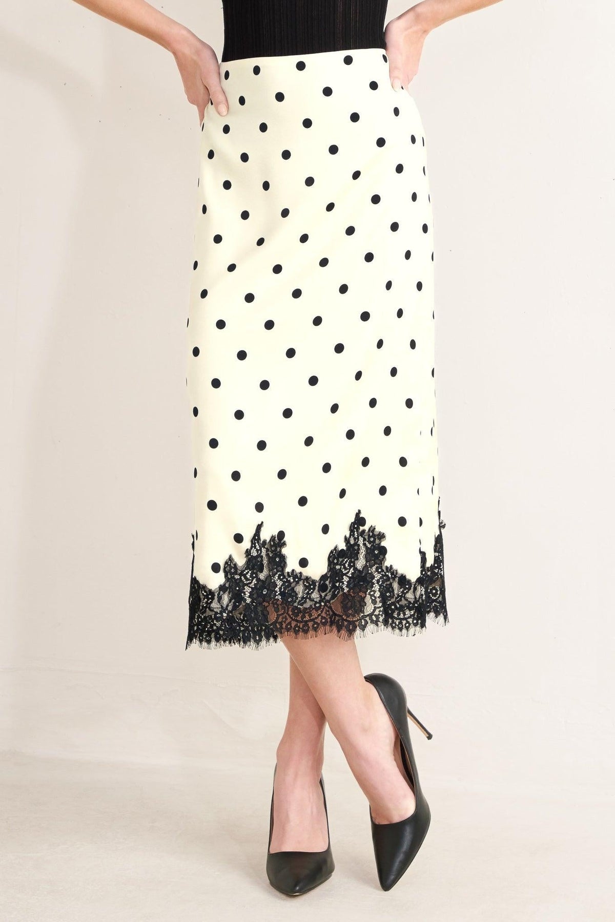 a woman wearing a skirt and heels