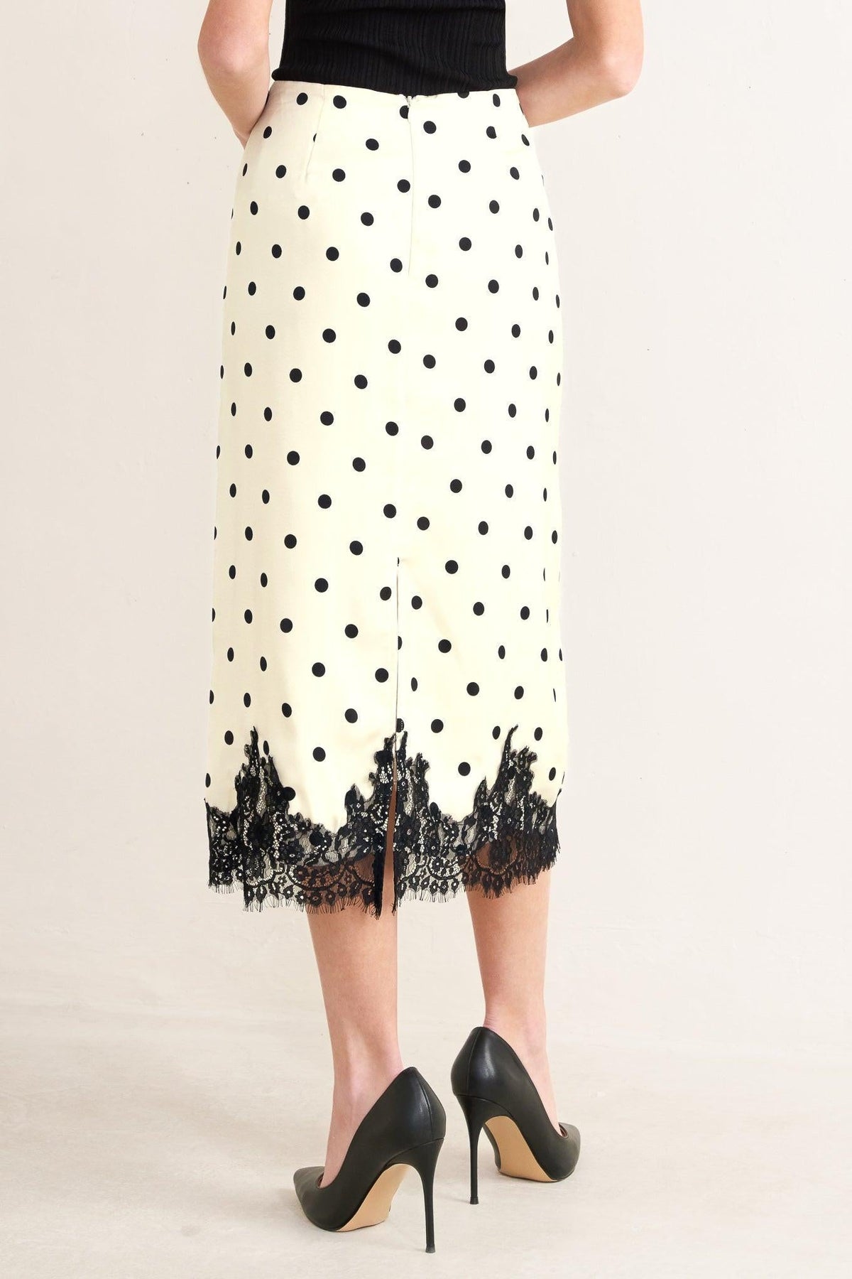 a woman wearing a skirt and heels