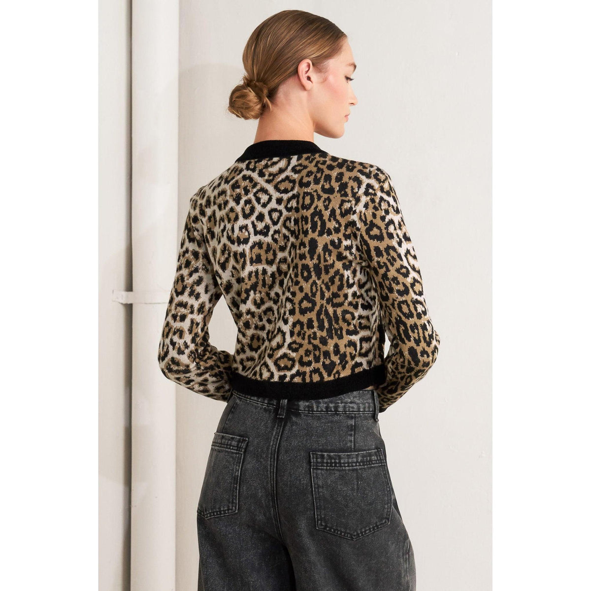 a woman in a leopard print sweater