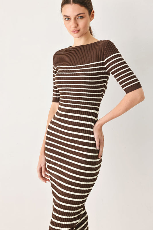 a woman in a brown and white striped dress