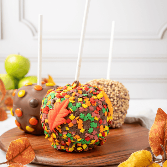 a group of candy apples on a wooden plate