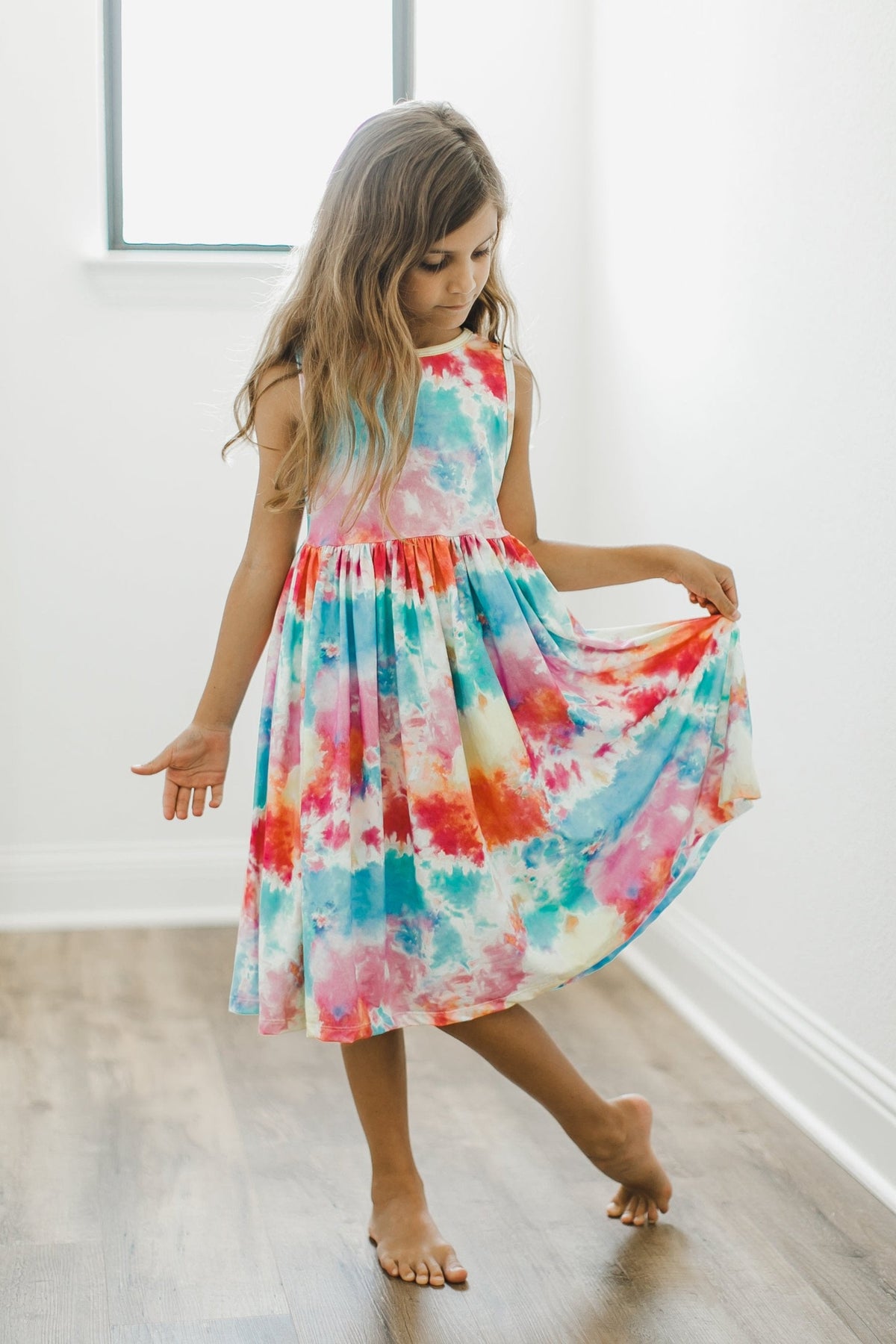 a girl in a tie dye dress