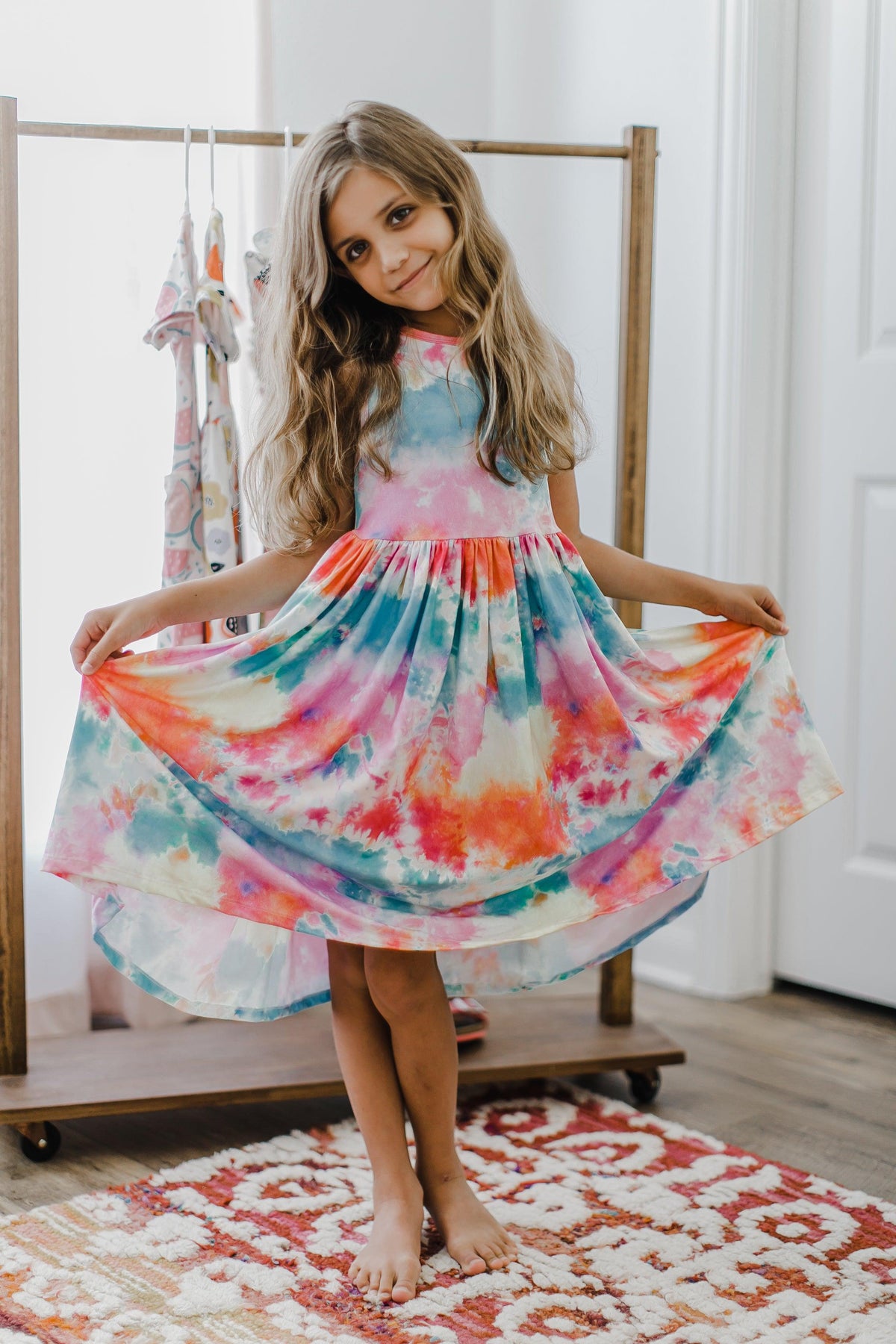 a girl in a tie dye dress