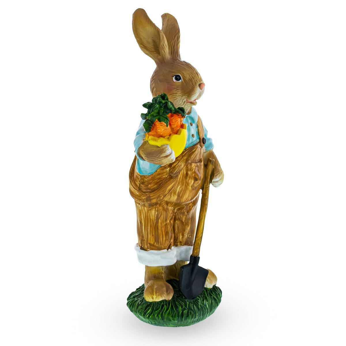 a statue of a rabbit holding a shovel and carrots