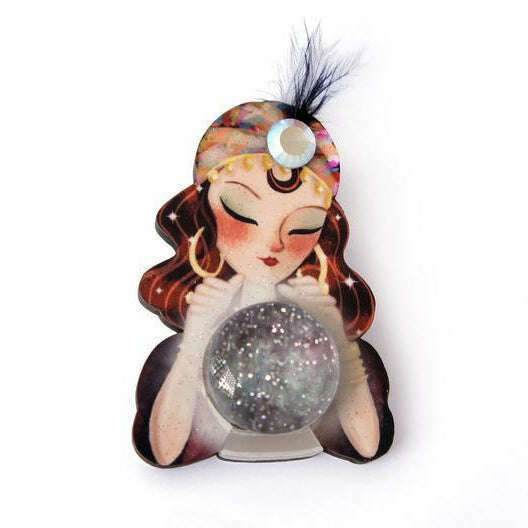 a small figurine of a woman holding a crystal ball