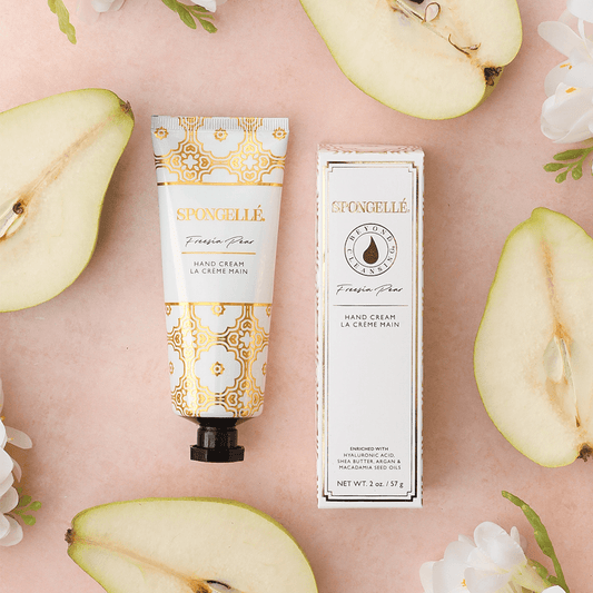 a tube of cream next to a pear cut in half