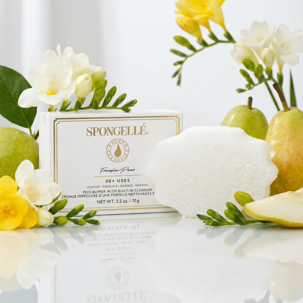 a box of fruit next to a white box with yellow flowers