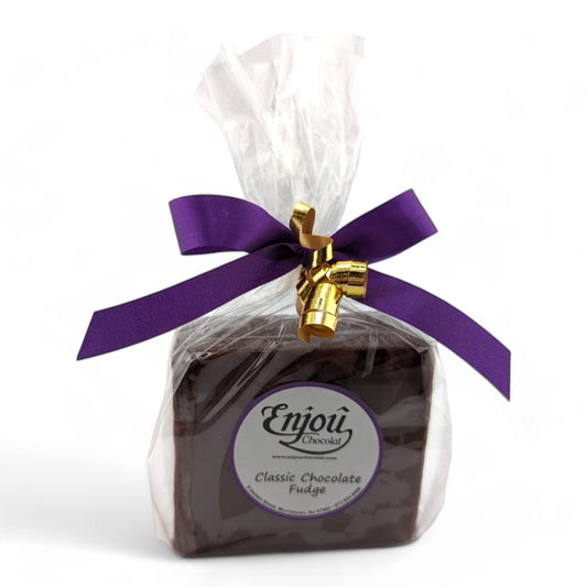 a chocolate fudge in a plastic bag with a purple bow