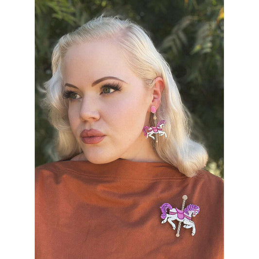 a woman with blonde hair wearing earrings