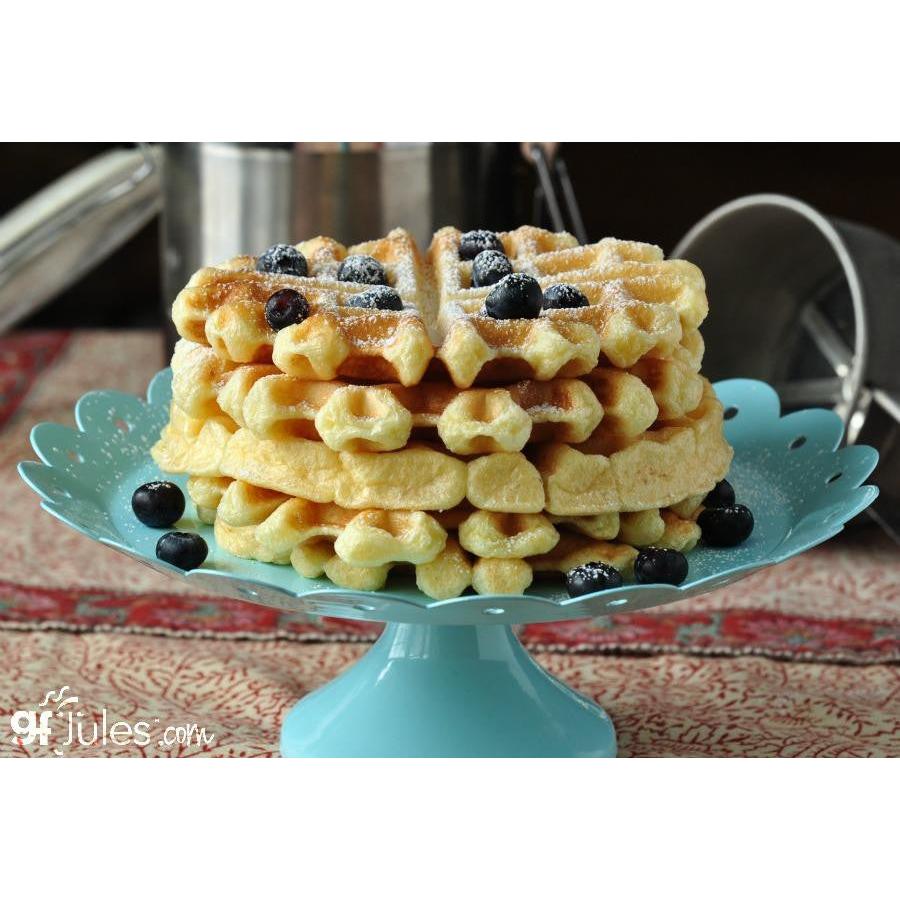 Stack of waffles with blueberries on a teal stand