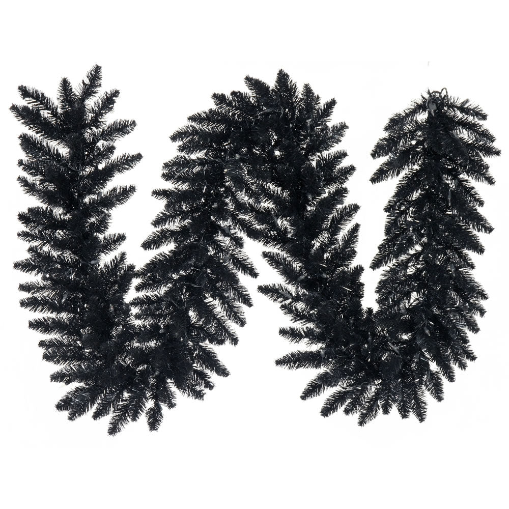 a black letter made of pine branches