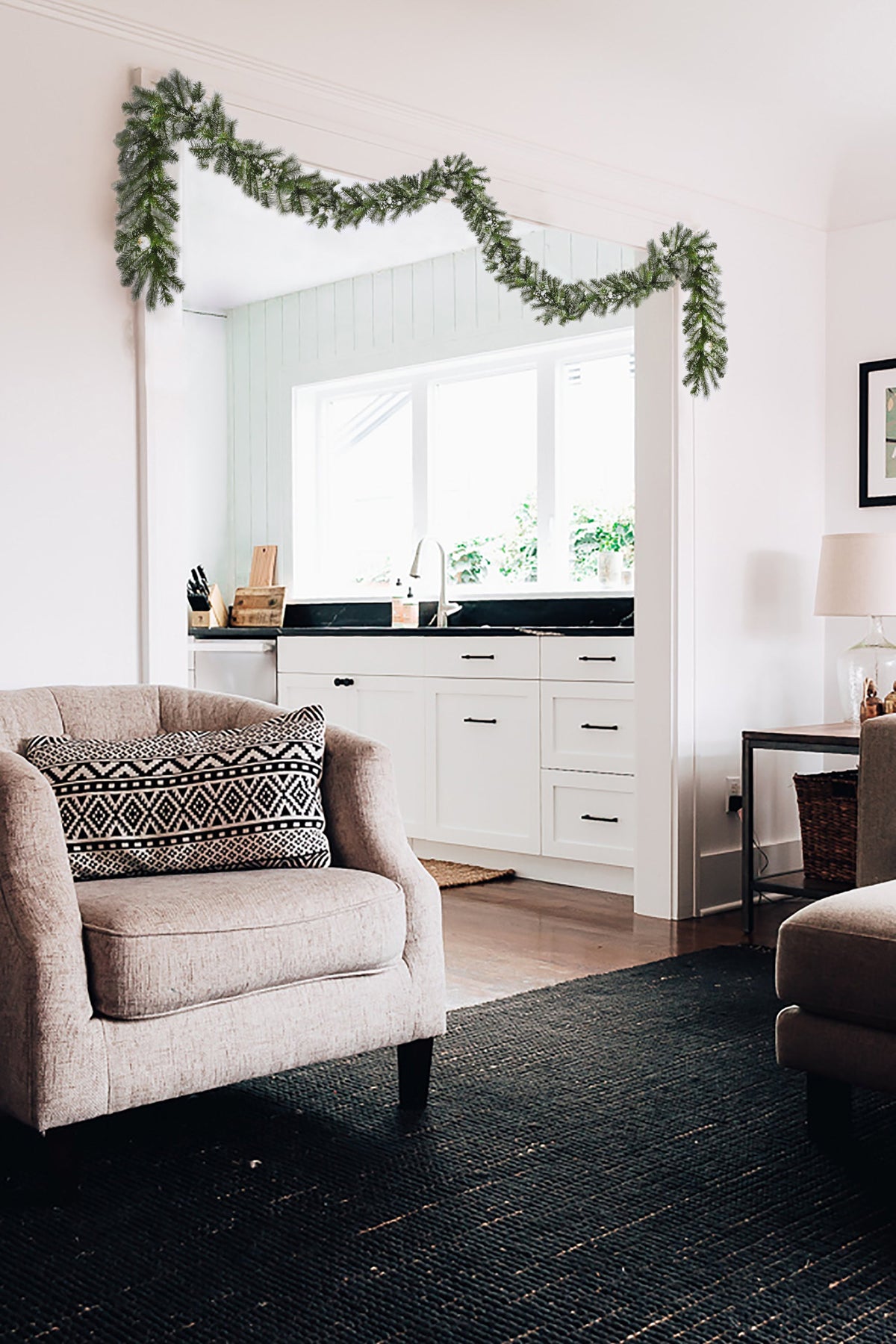 a living room with a couch and a kitchen