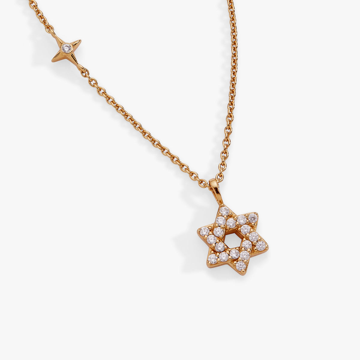 a gold necklace with a star and diamonds