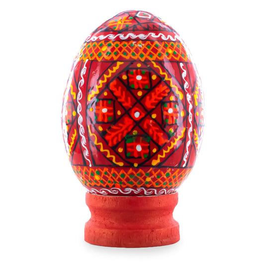 a red and orange egg with a red base