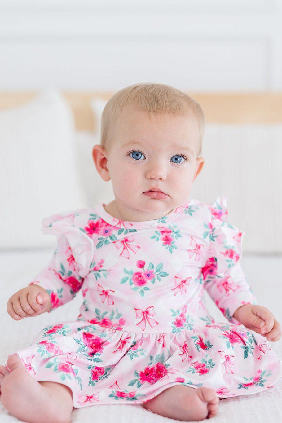 a baby in a pink dress