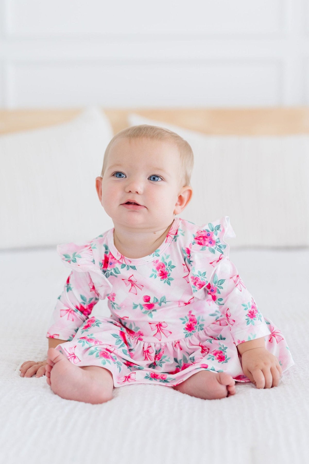 a baby sitting on a blanket
