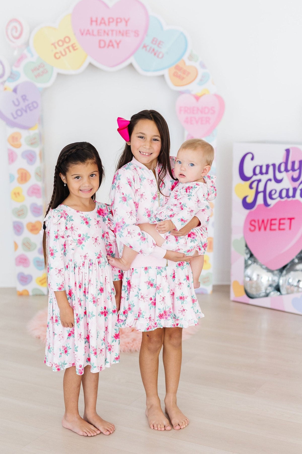 a group of girls holding a baby