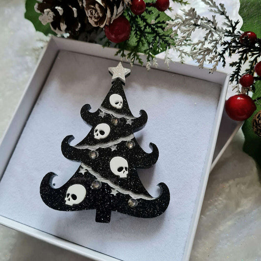 a black and white christmas tree decoration in a white box