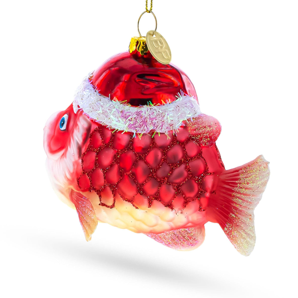 a red fish ornament with a gold circle and a gold coin