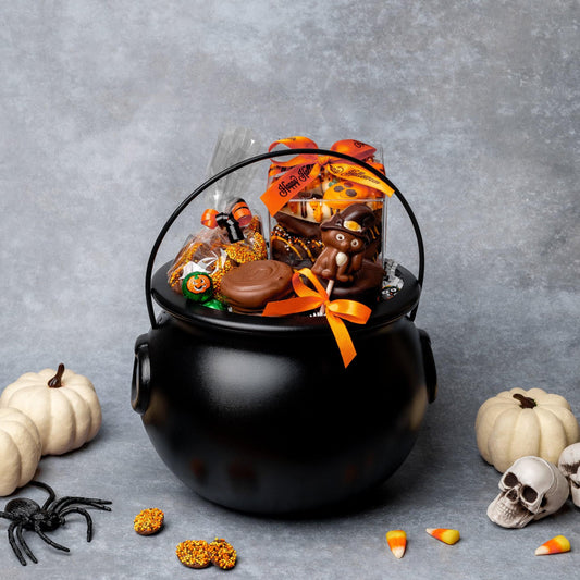 a black cauldron with candy and skulls